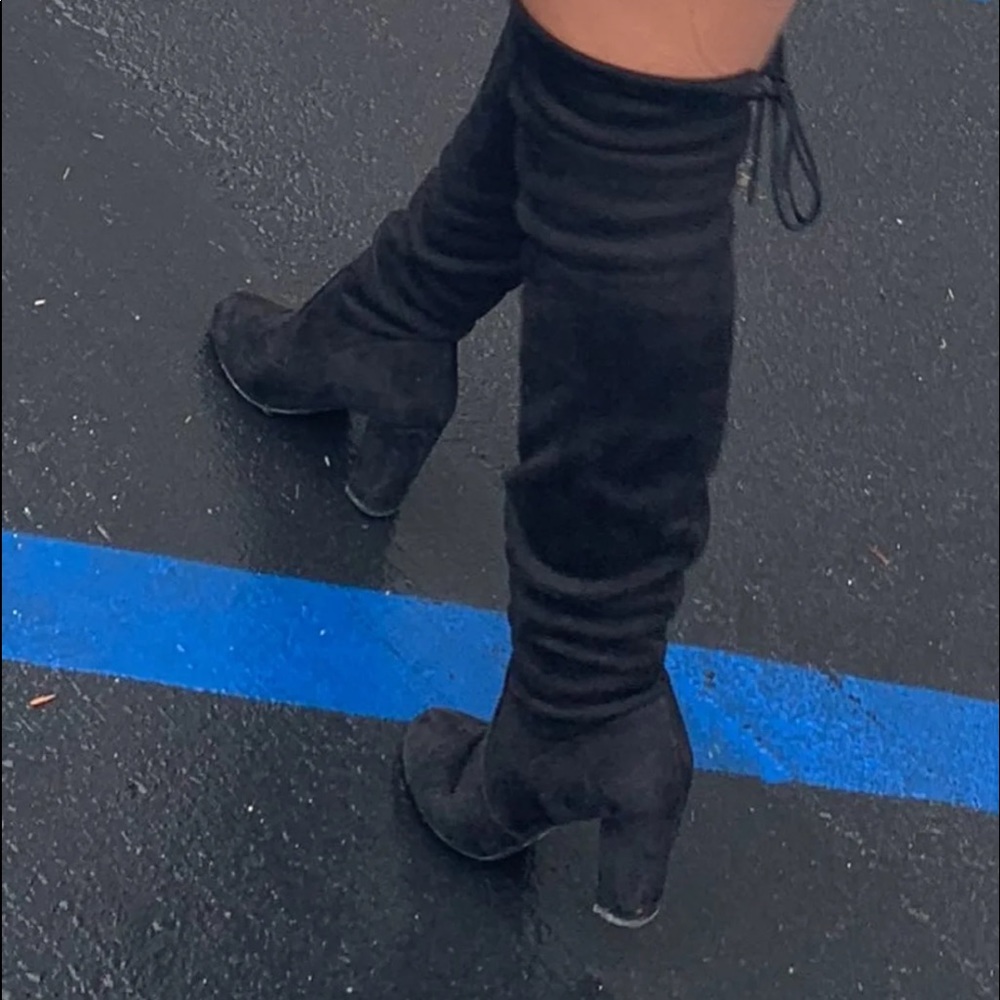 Black thigh high heeled boots